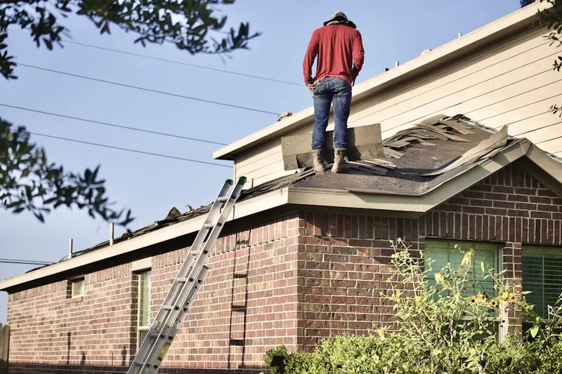 Professional roofer working on a residential roof in Green Hills Estates